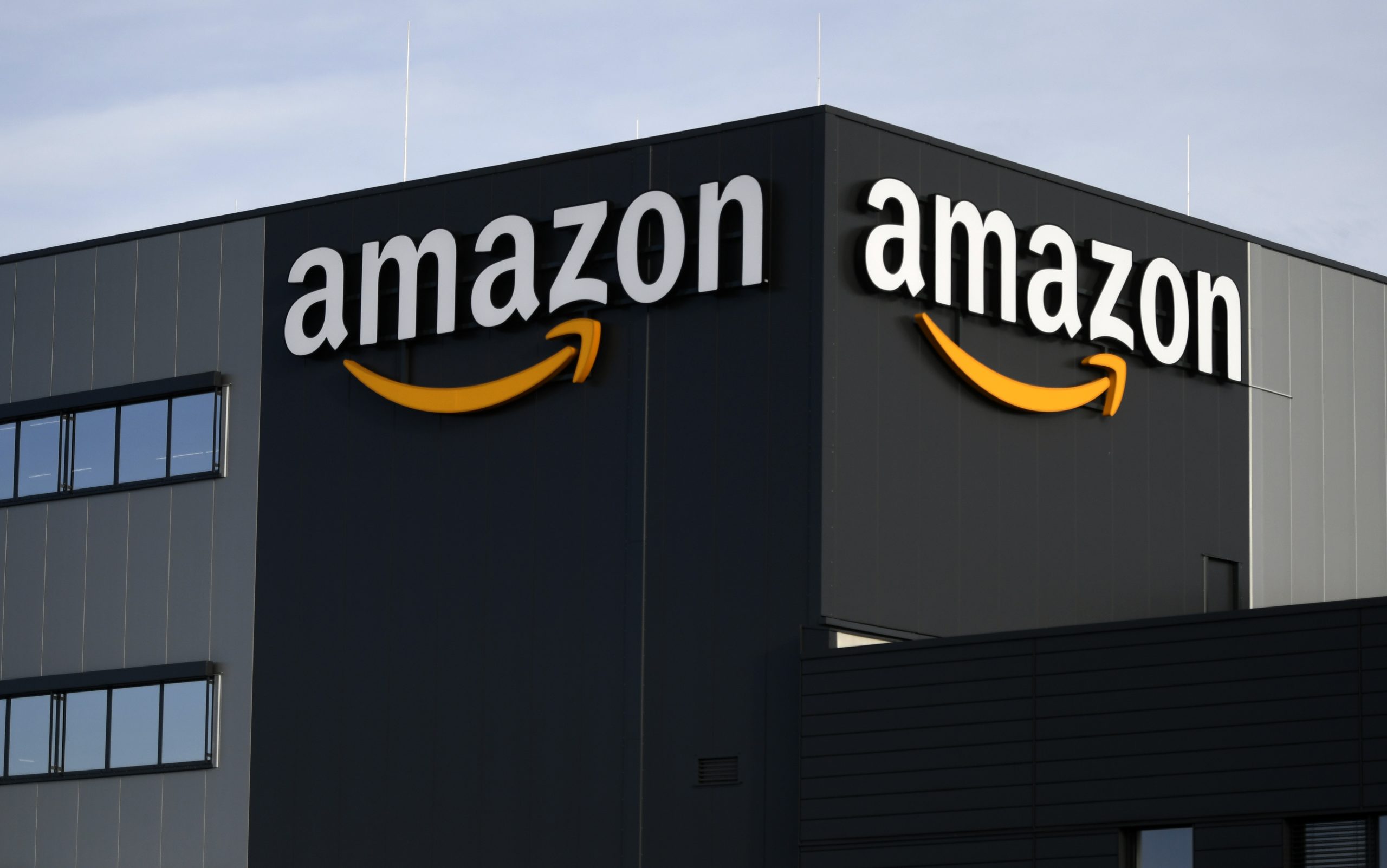 (FILES) In this file photo taken on December 17, 2019 This picture shows the logo of US online retail giant Amazon at the distribution centre in Moenchengladbach, western Germany. – Labor unions are urging regulators to investigate whether US tech giant Amazon is abusing its dominance in online retail, cloud computing and logistics. In a petition filed on February 27, 2020 with the Federal Trade Commission, the International Brotherhood of Teamsters and other labor groups claiming to represent a total of 5.3 million workers accused Amazon of anticompetitive practics. (Photo by INA FASSBENDER / AFP)